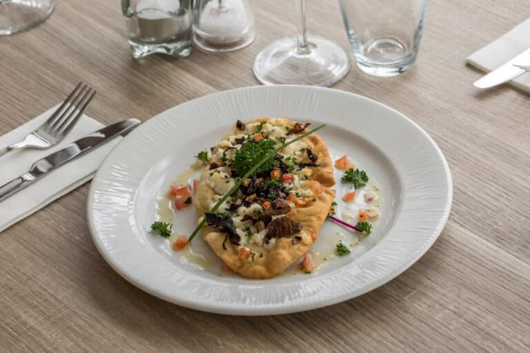 Wild mushroom flatbread with vegetables from top down view