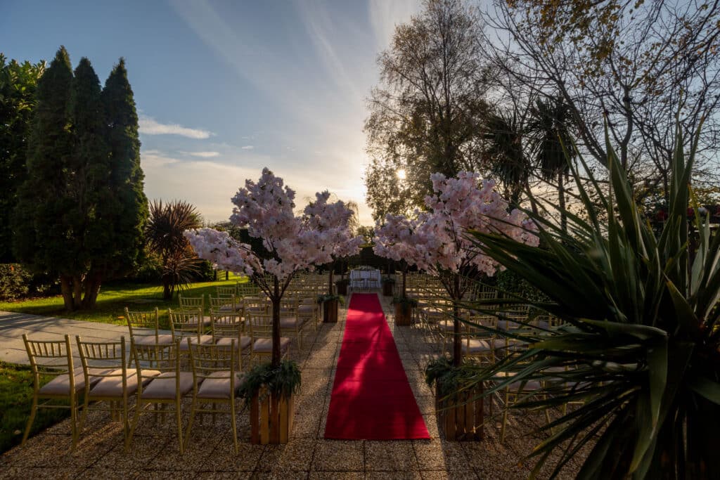 Glenside Hotel view of civil ceremony outside with sun shining through top view