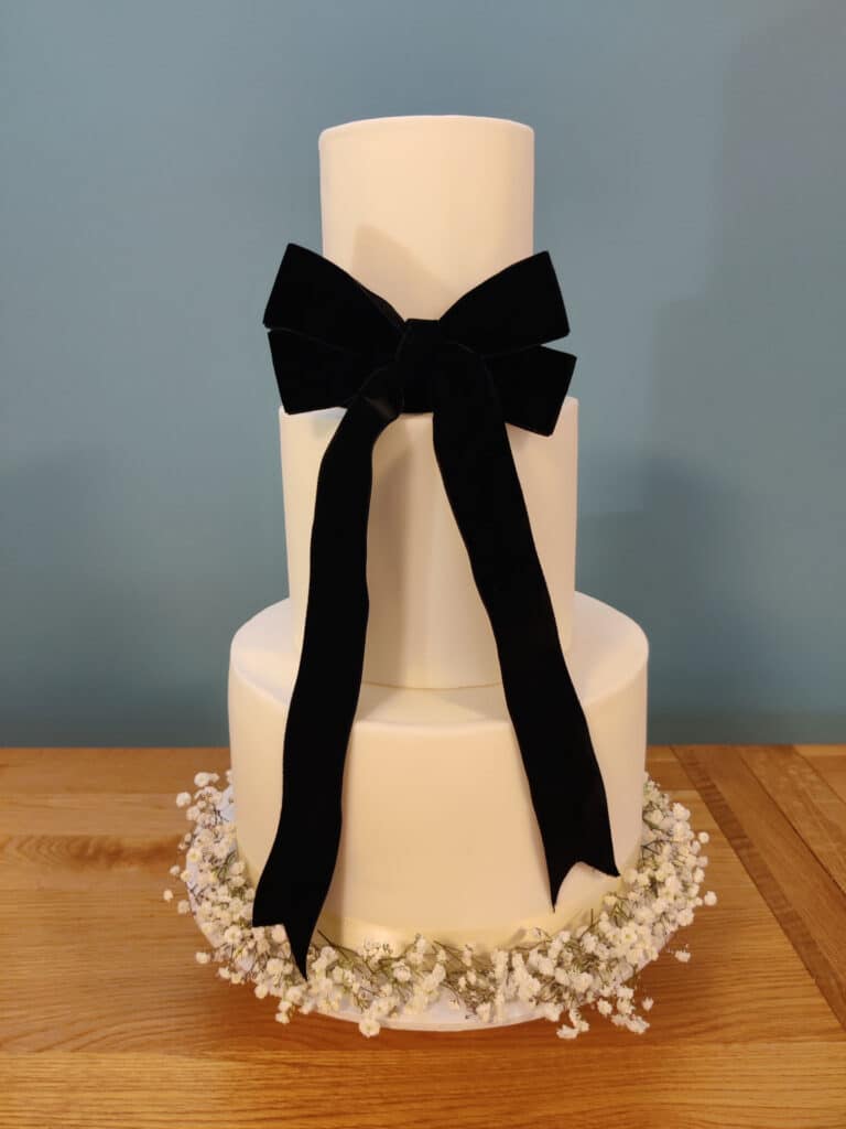 3 tiered wedding cake with black velvet bow